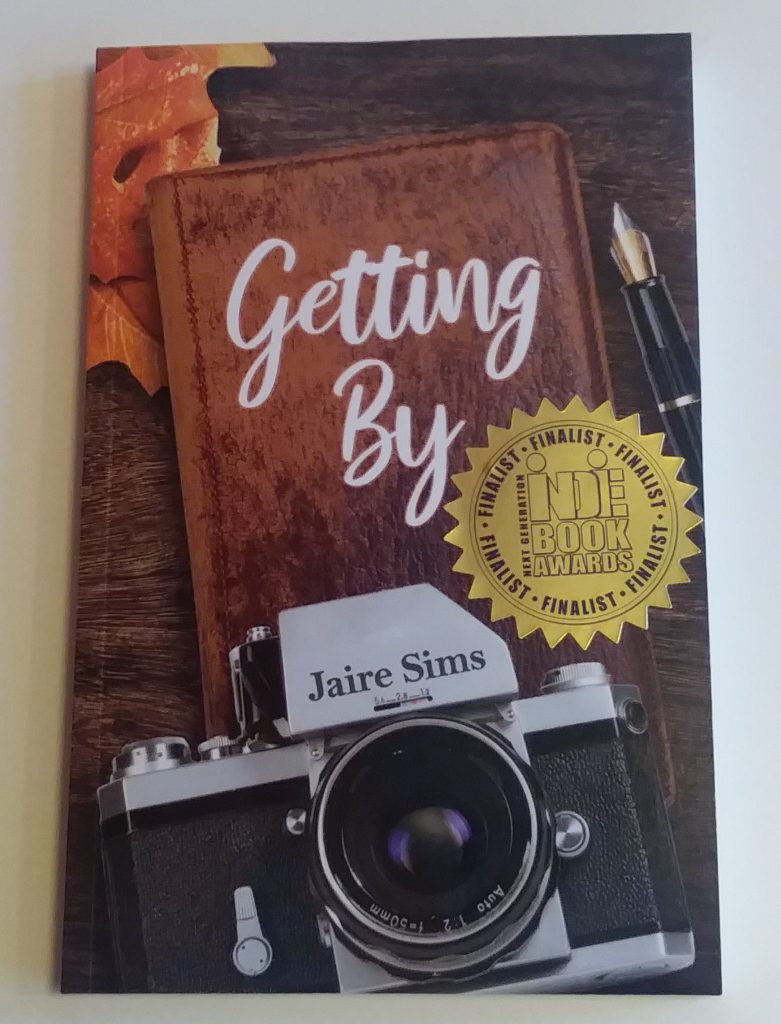 A copy of the book, Getting By, with an award sticker on the cover. 