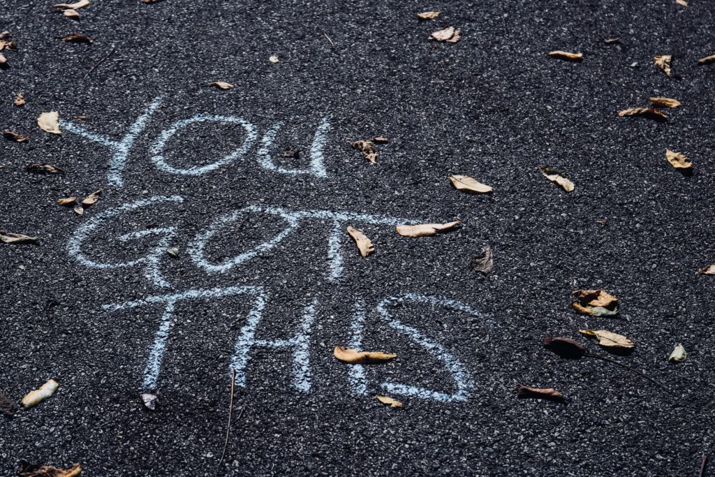 Chalk writing on a pavement that reads "You Got This."