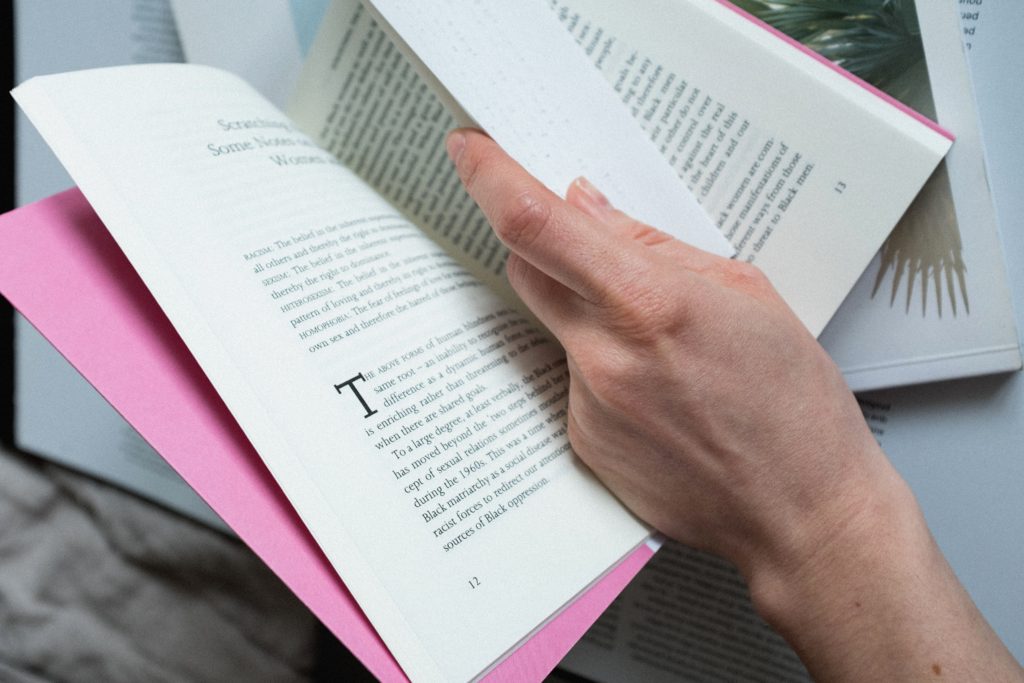 A person turning a page in a book. 