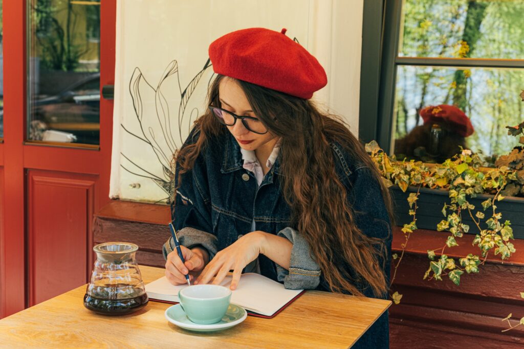 A young woman writing on a notebook. 