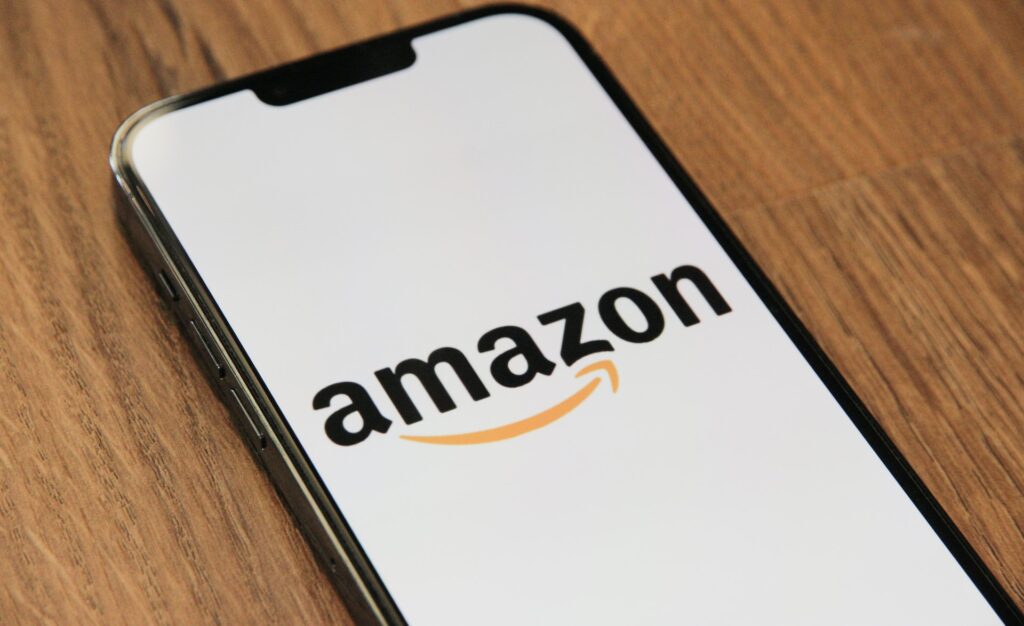 A cell phone with an Amazon logo on the screen. 