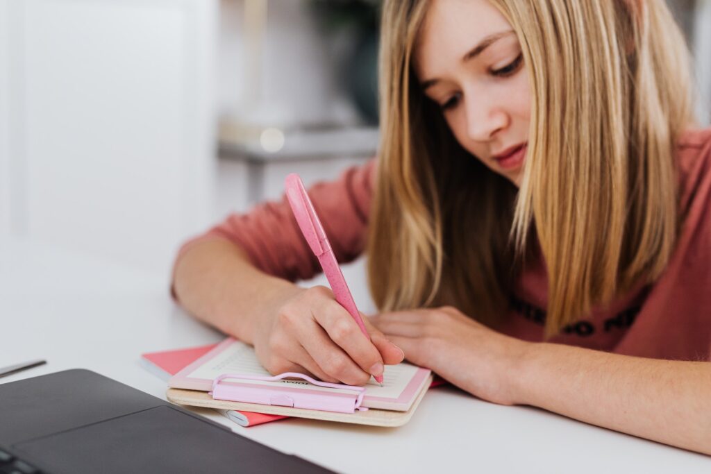 A girl writing ideas to write a great hook for her novel. 