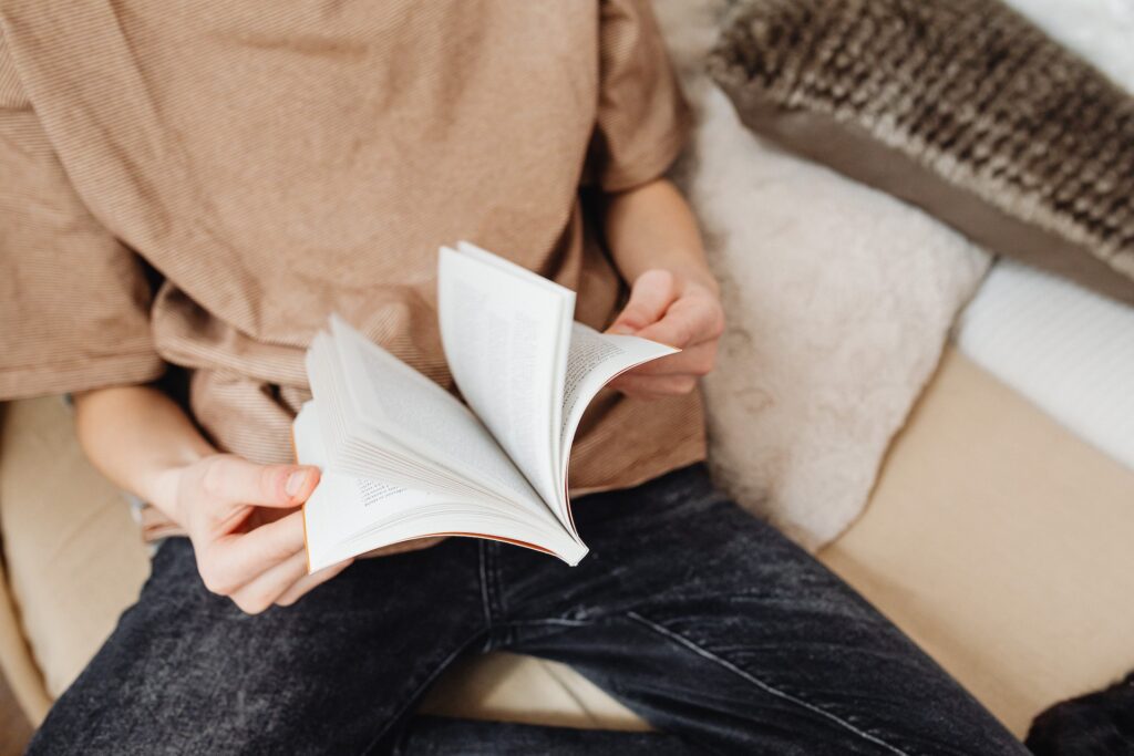 A person in flipping pages of a YA book. 