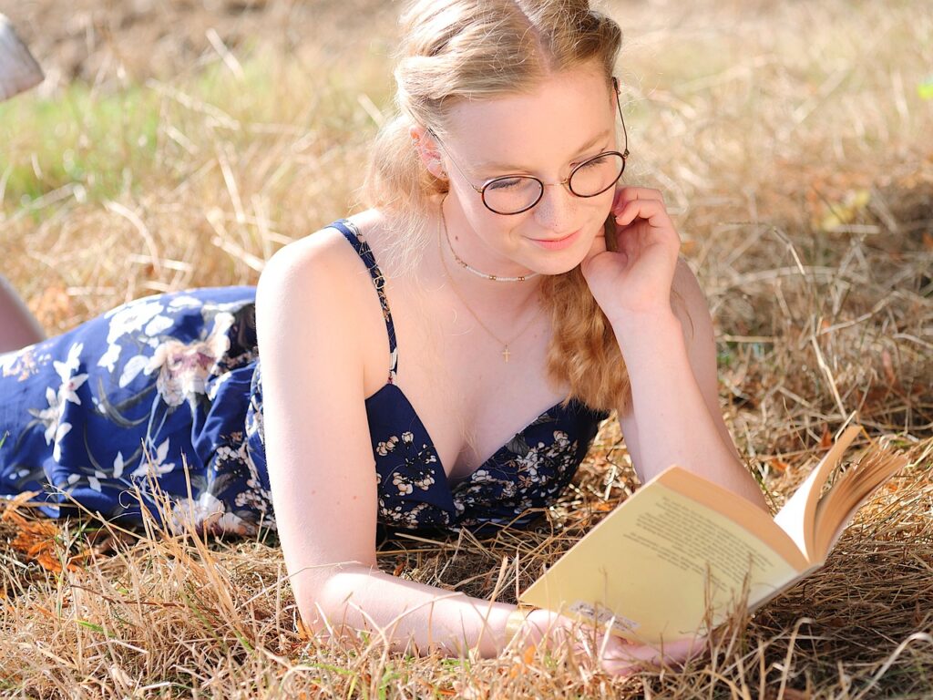 A teenager line reading a book about choosing the right tense for your novel