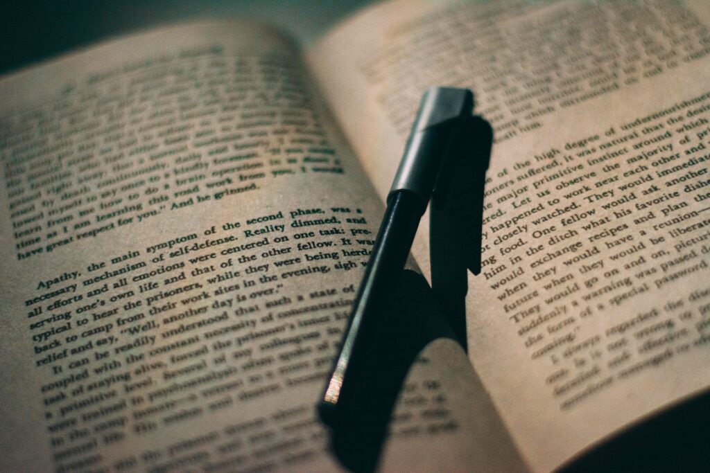 A black pen on an open book. 