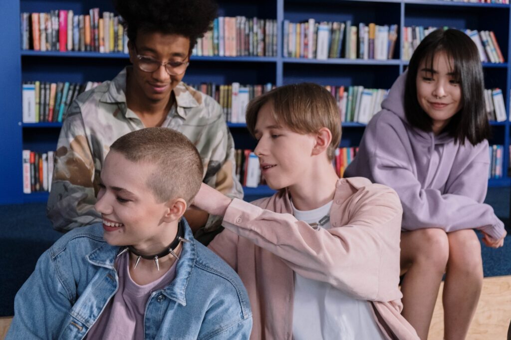 A diverse group of teens in a library. Diverse representation is important in YA Fiction. 
