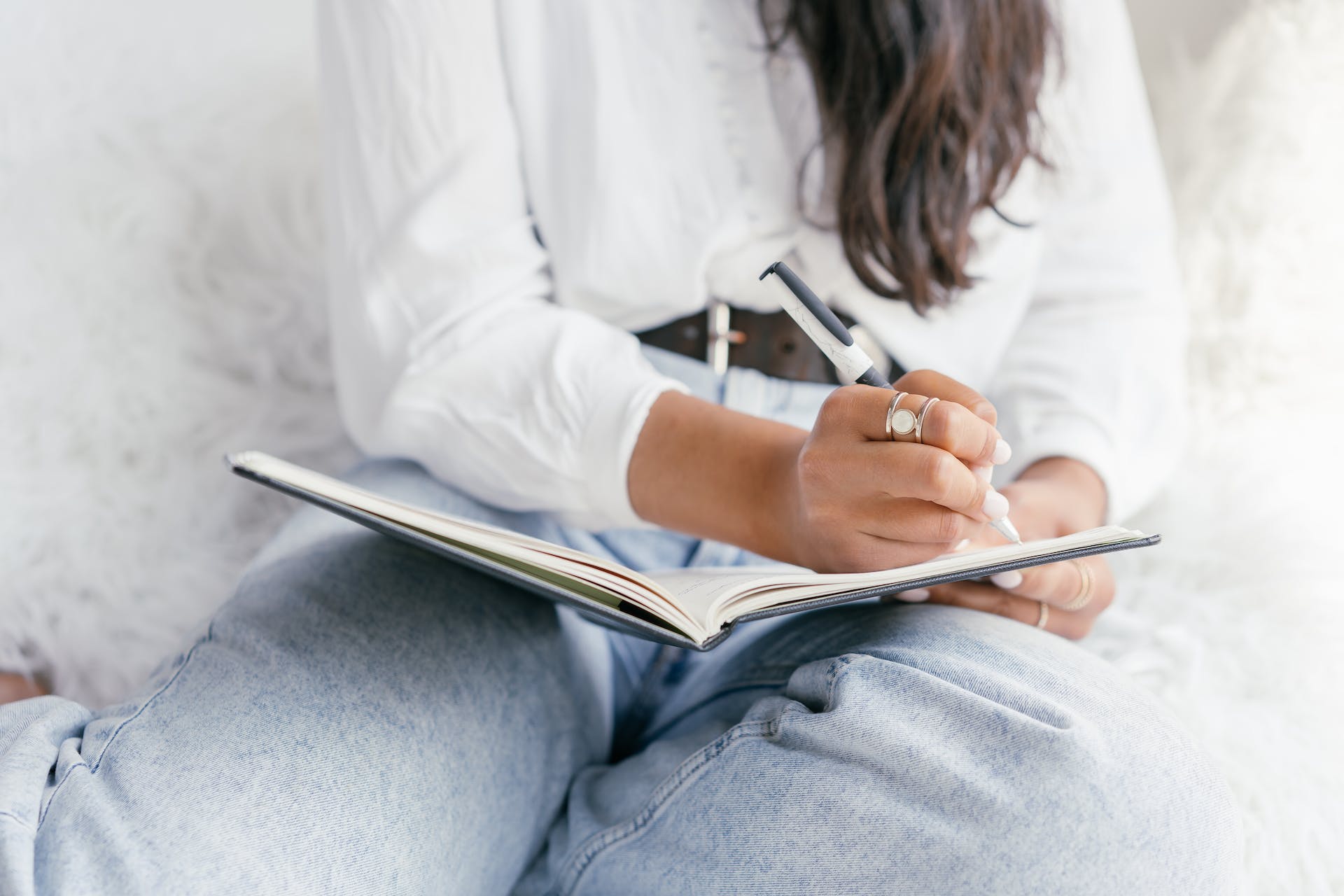 A person writing on a notebook.