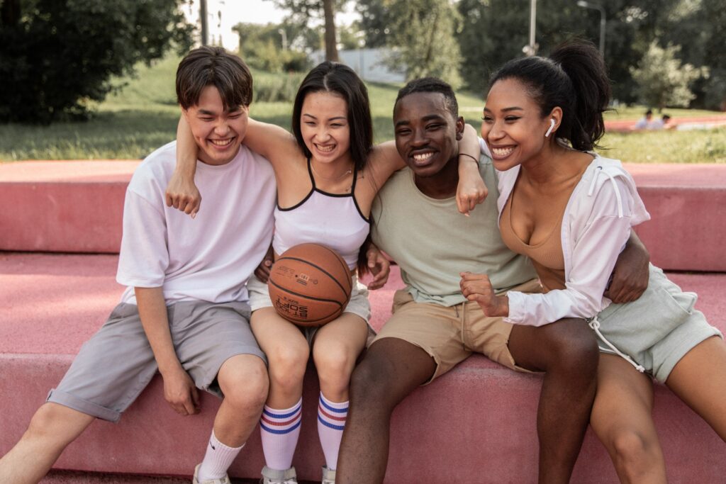 A group of friends embracing on a bench.