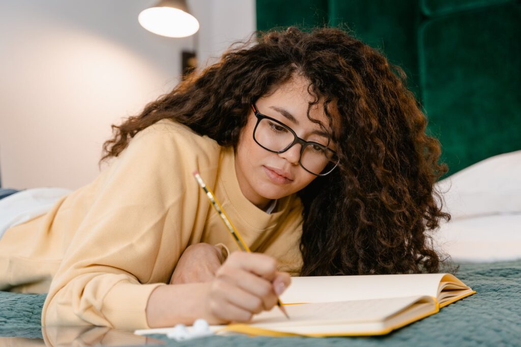 A girl writing on a notebook. 
